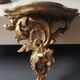 Small Italian/Baroque wall-mounted console. In gilded wood.