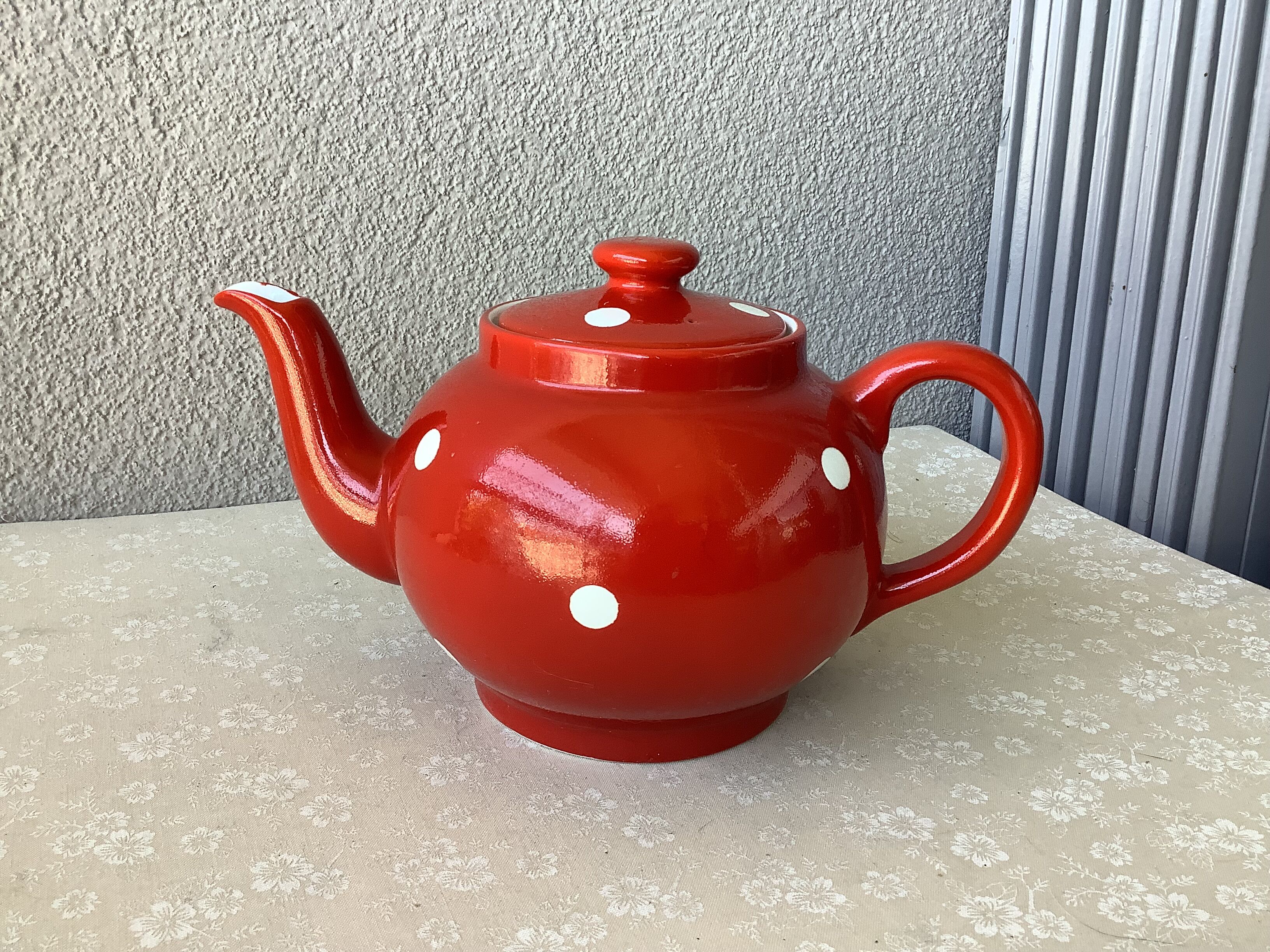 Vintage red teapot with white polka dots