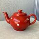 Vintage red teapot with white polka dots