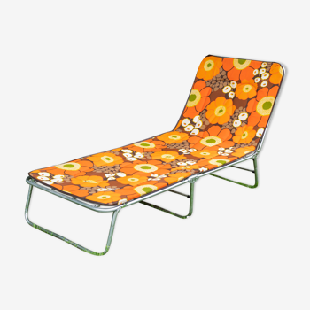 Vintage camp bed with orange flowers