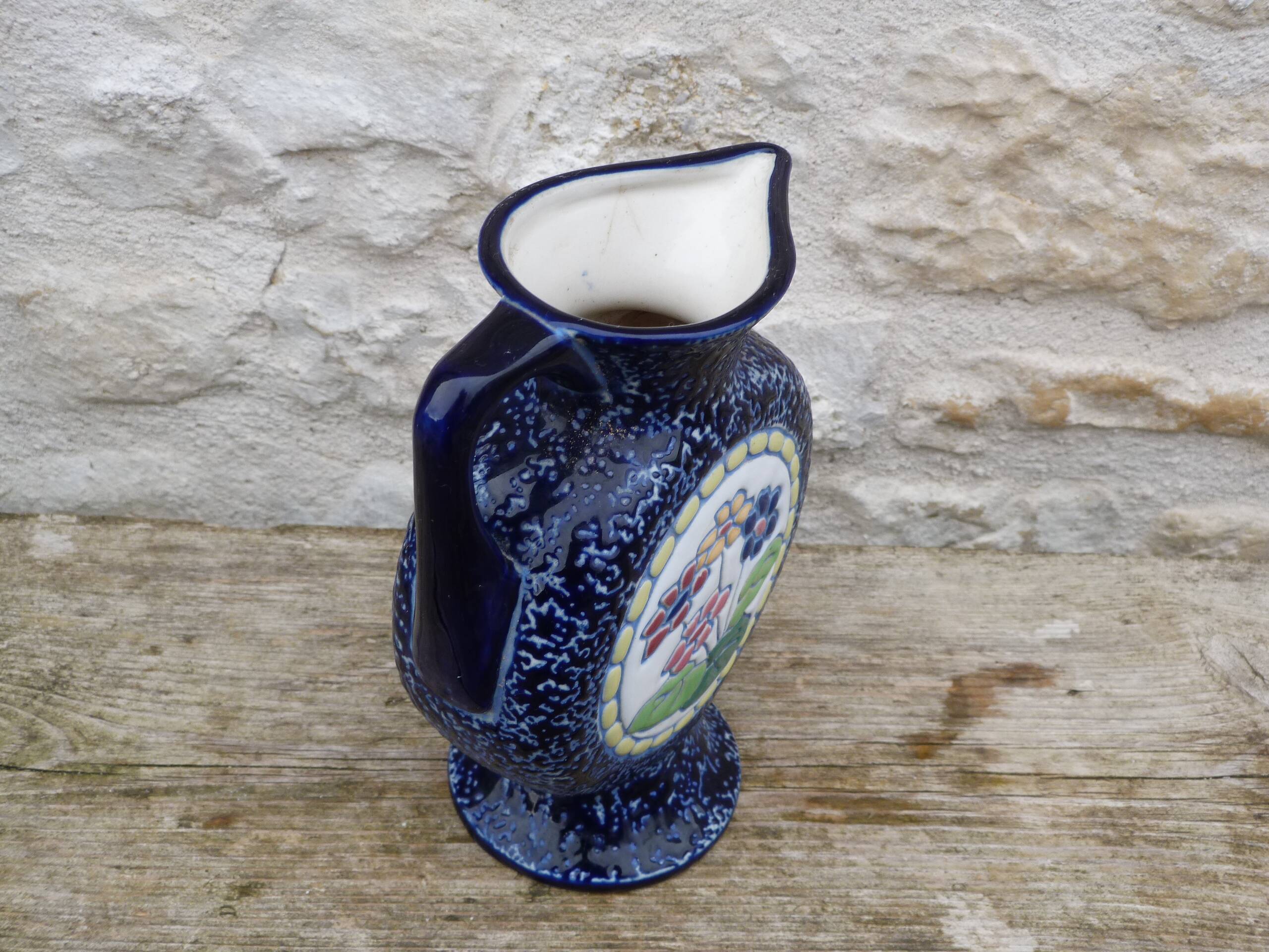 Blue ceramic vase with floral motifs