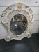 Patinated wooden bull's-eye mirror