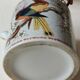 Japanese ceramic teapot. bird/paradise motifs/cherry trees. bamboo/rattan braided handle