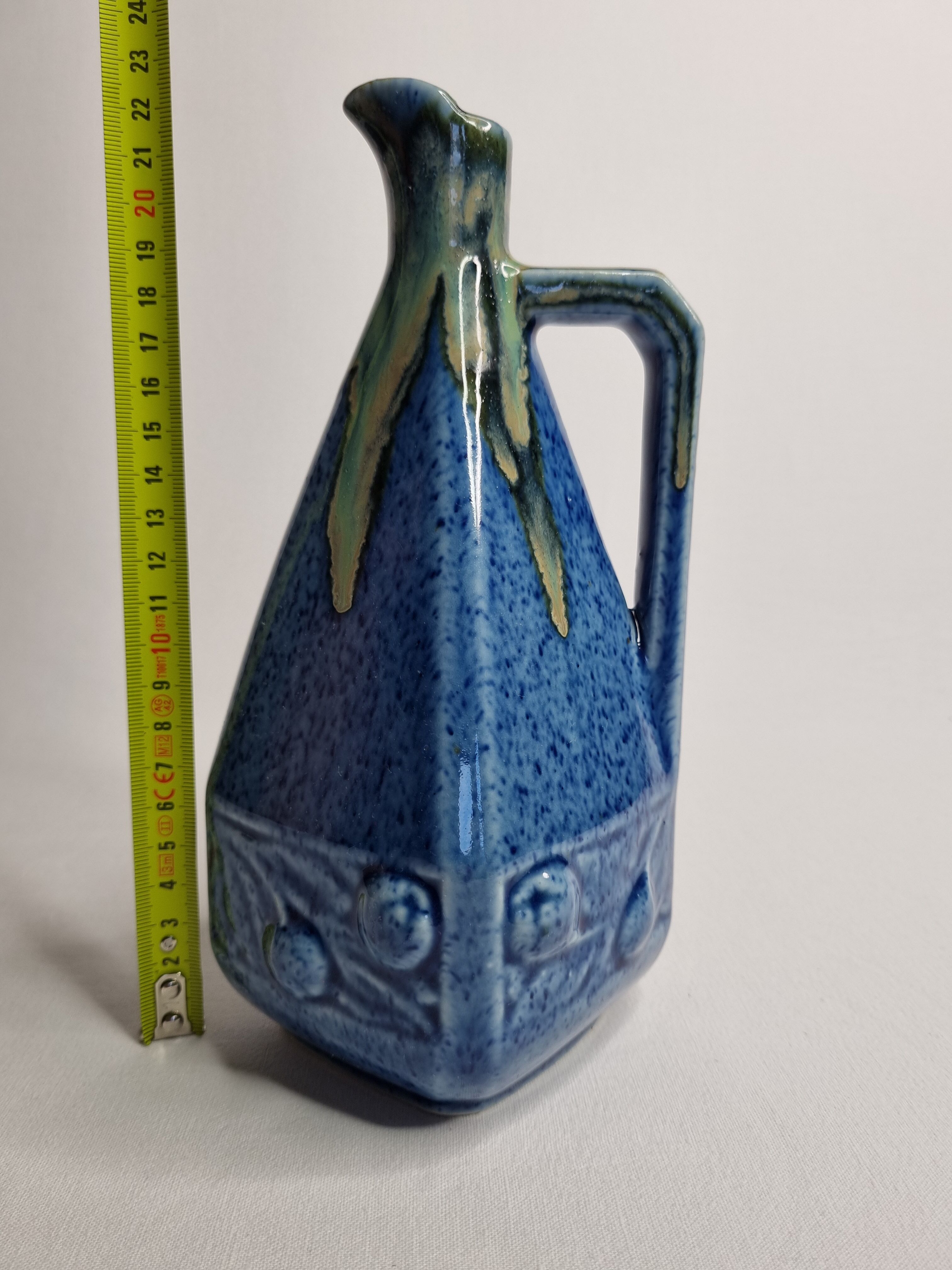Art Deco pitcher in blue enamelled sandstone with fruit decoration, 22 cm