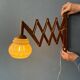 Vintage wall lamp with teak wood scissors and glass shade.