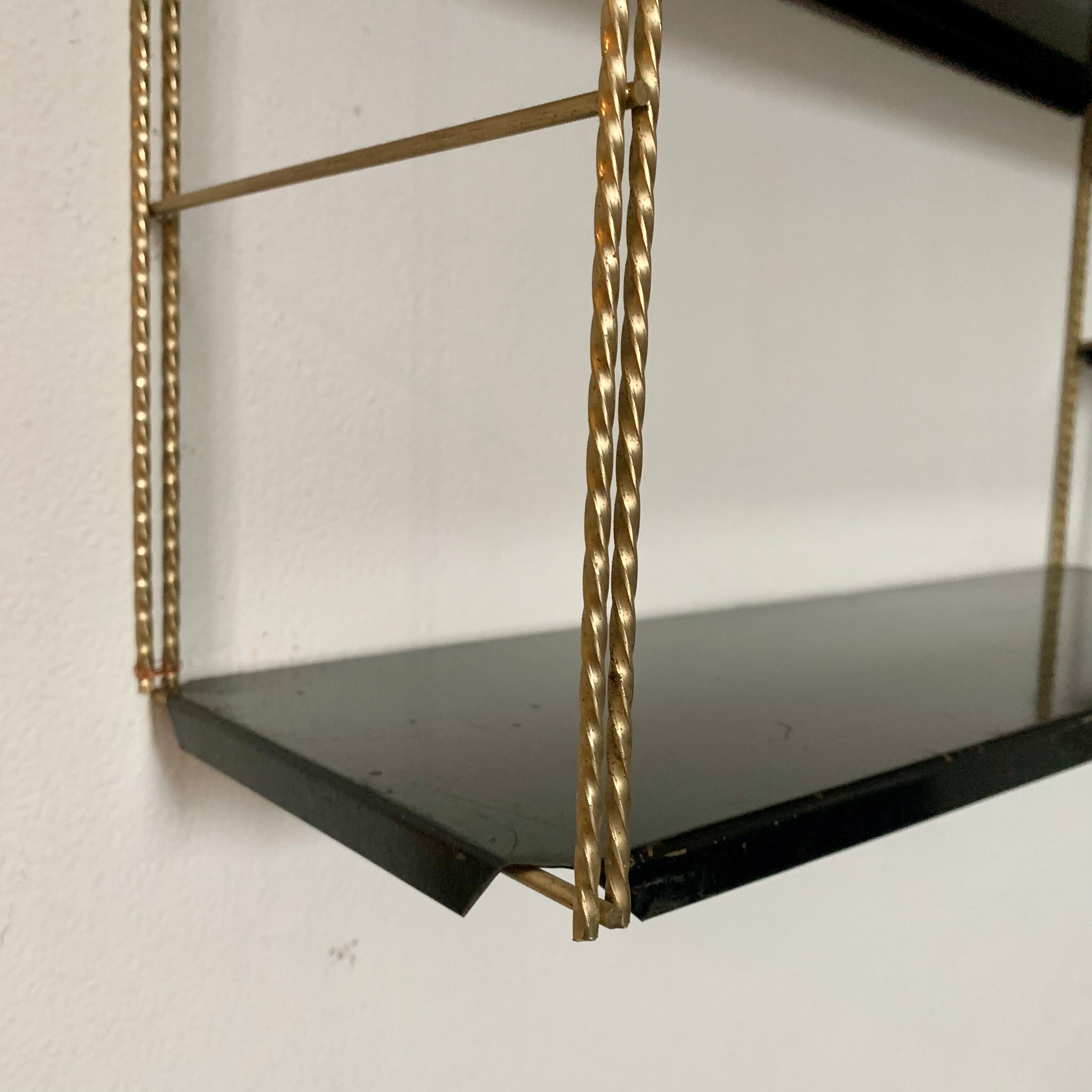 Vintage wall shelves in gold and black metal
