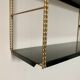 Vintage wall shelves in gold and black metal