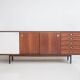 Wooden sideboard with sliding door and white drawers, around 1960.