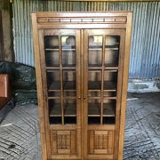 Vintage oak bookcase from the reconstruction period with 2 doors with small panes.