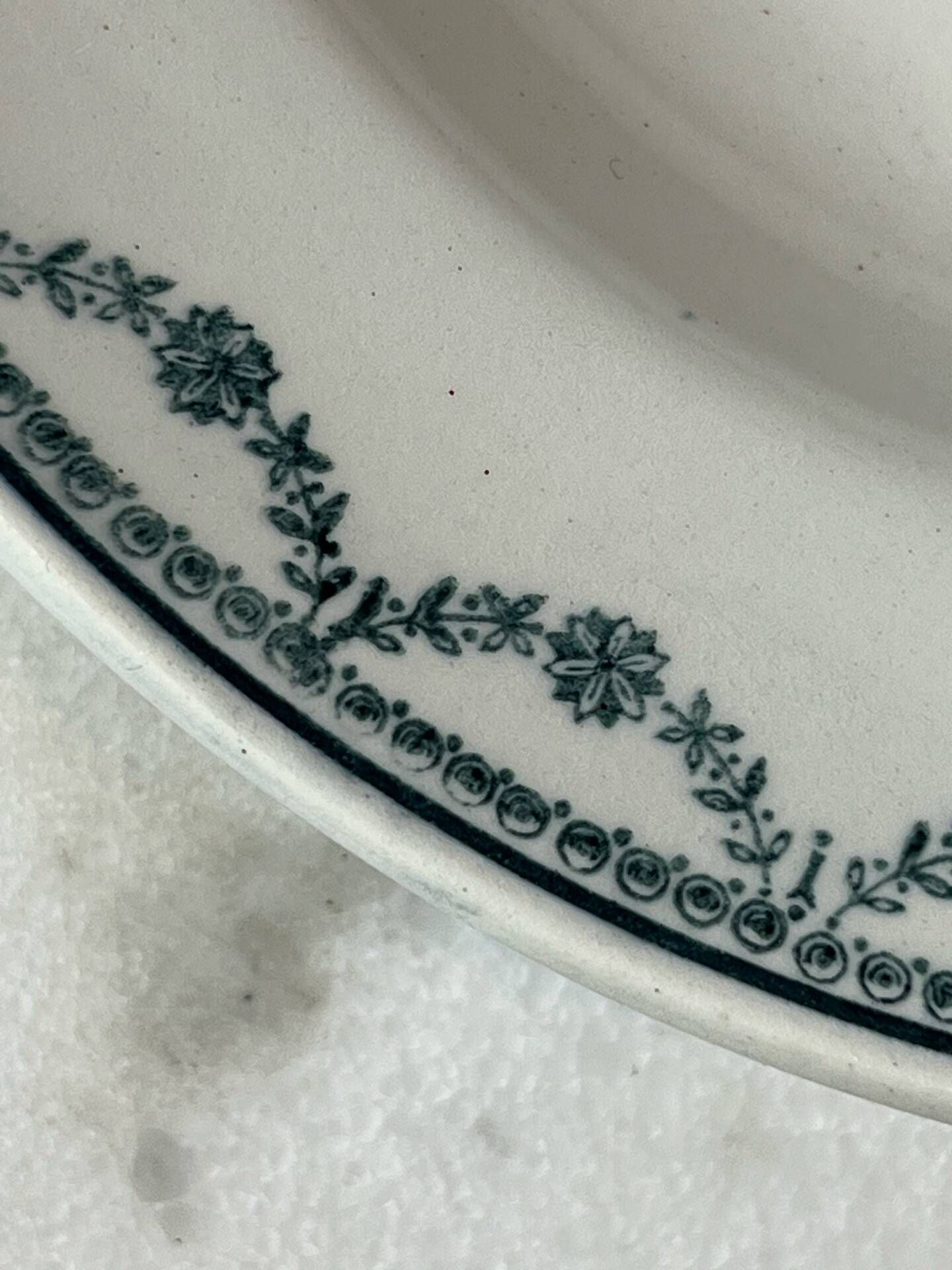 Set of 12 deep plates Saint Amand with floral garland decoration.