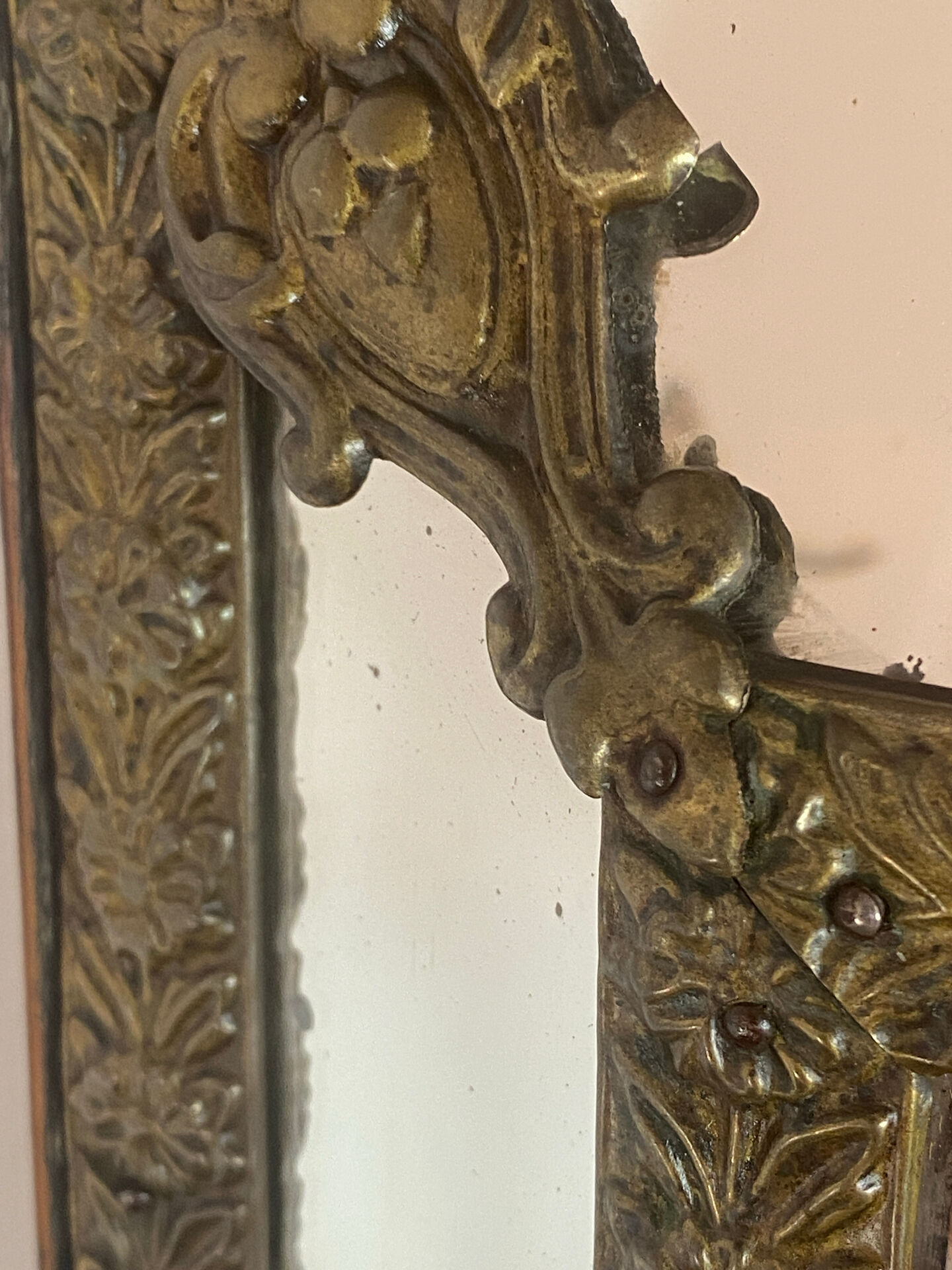 Mirror with brass repoussé frame