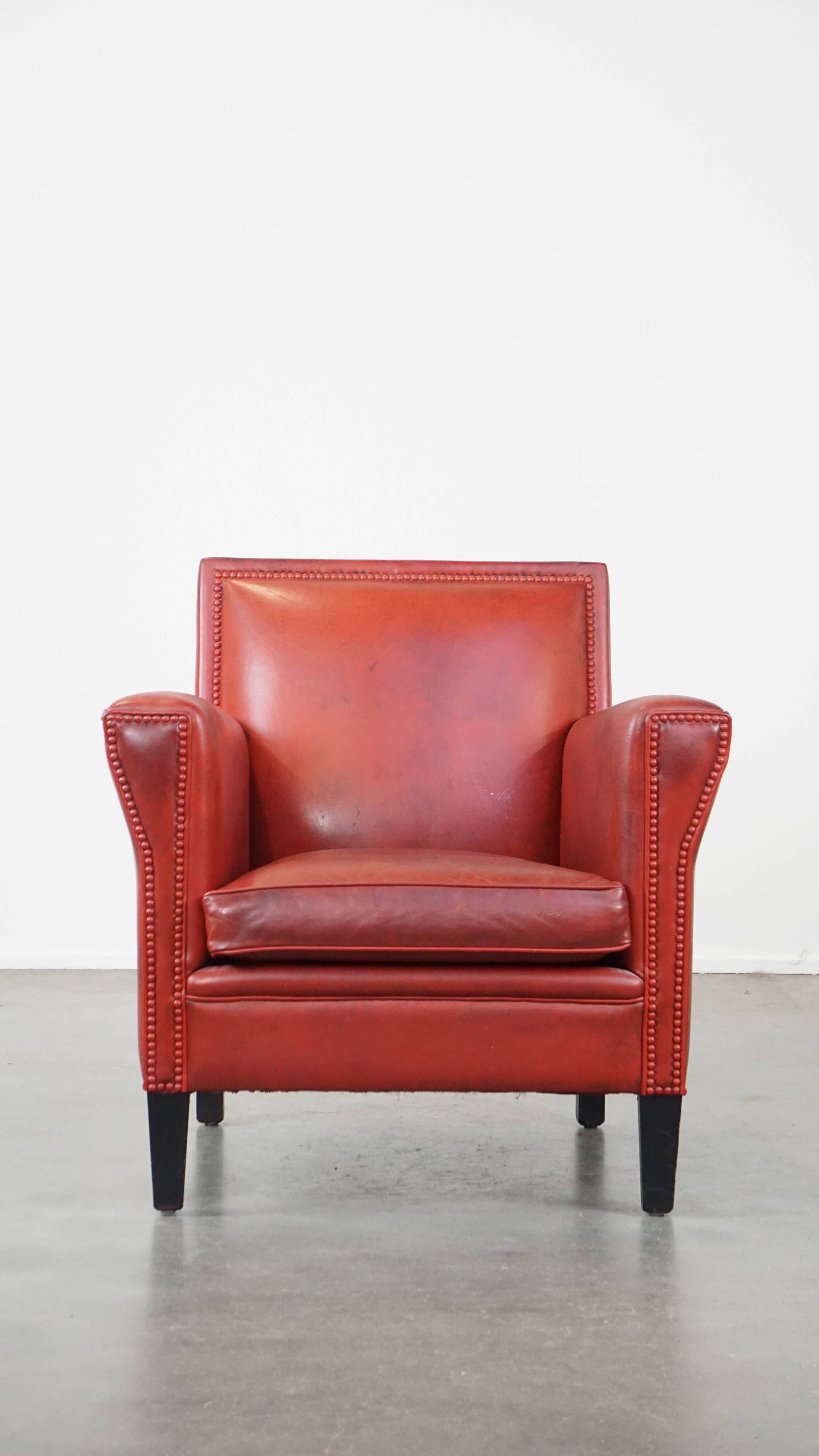 Red-painted armchair made of sheepskin leather