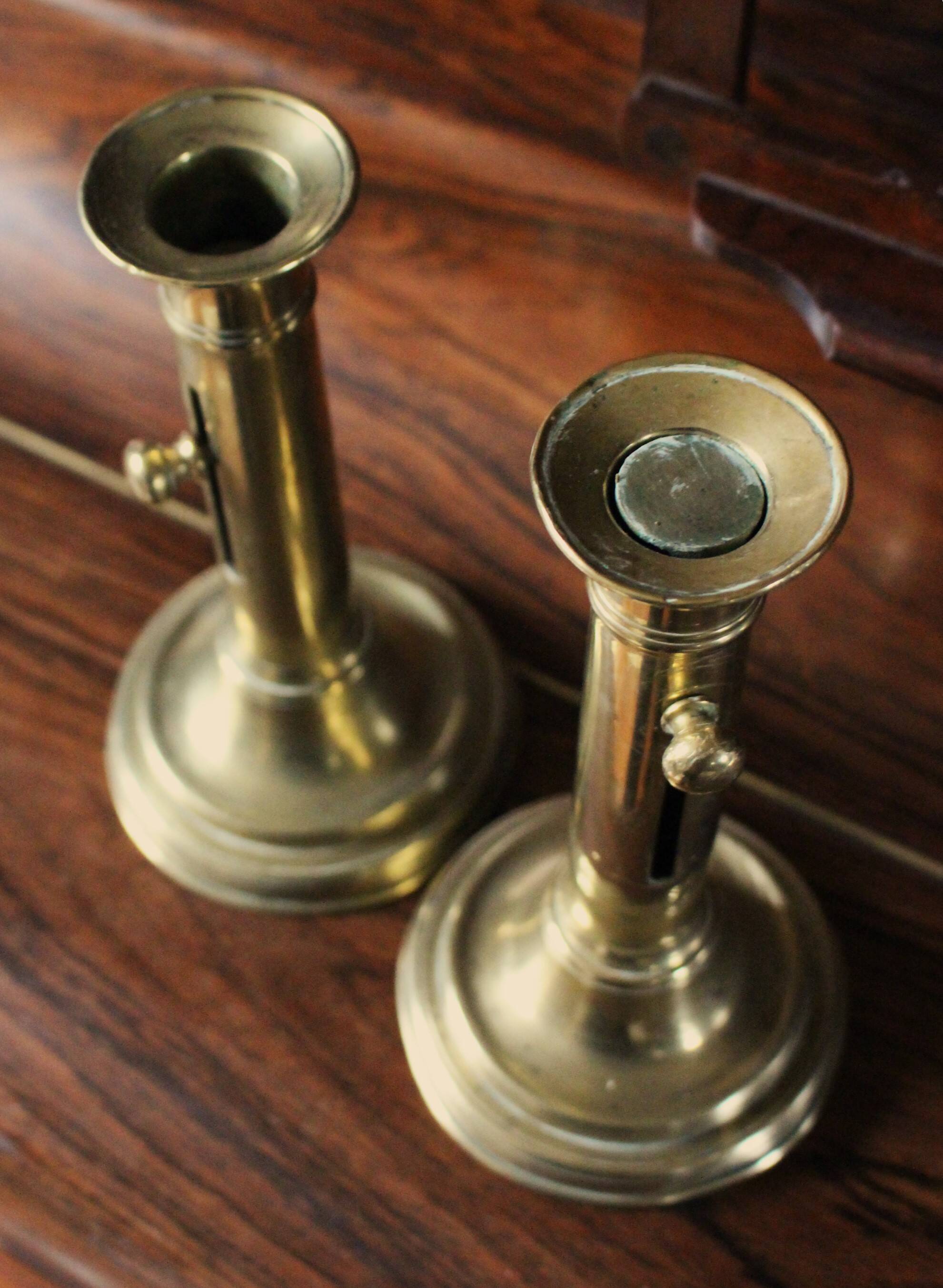 Pair of brass push-button candlesticks