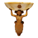 Wall lamp, where the base is a carved wooden lady holding the shade which is made of alabaster 1920s