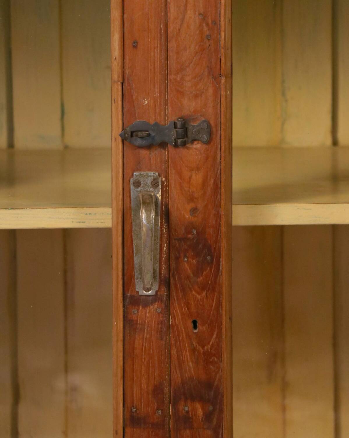 Antique Art Deco display cabinet in Burmese teak with original yellow patina interior.