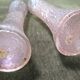 Pair of iridescent glass vases with relief decoration reminiscent of plant motifs.