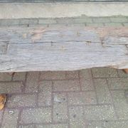 French country style cast iron bench with old rustic wooden plank