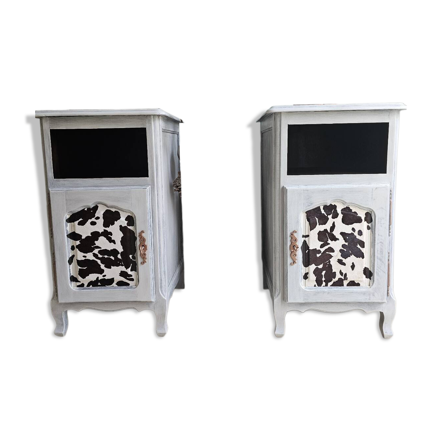 Two solid wood bedside tables with calfskin decoration.