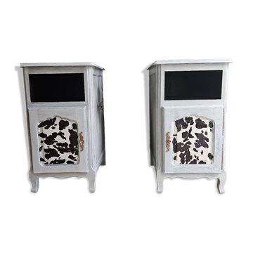 Two solid wood bedside tables with calfskin decoration.