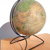 Old illuminated globe world map made of glass and paper.