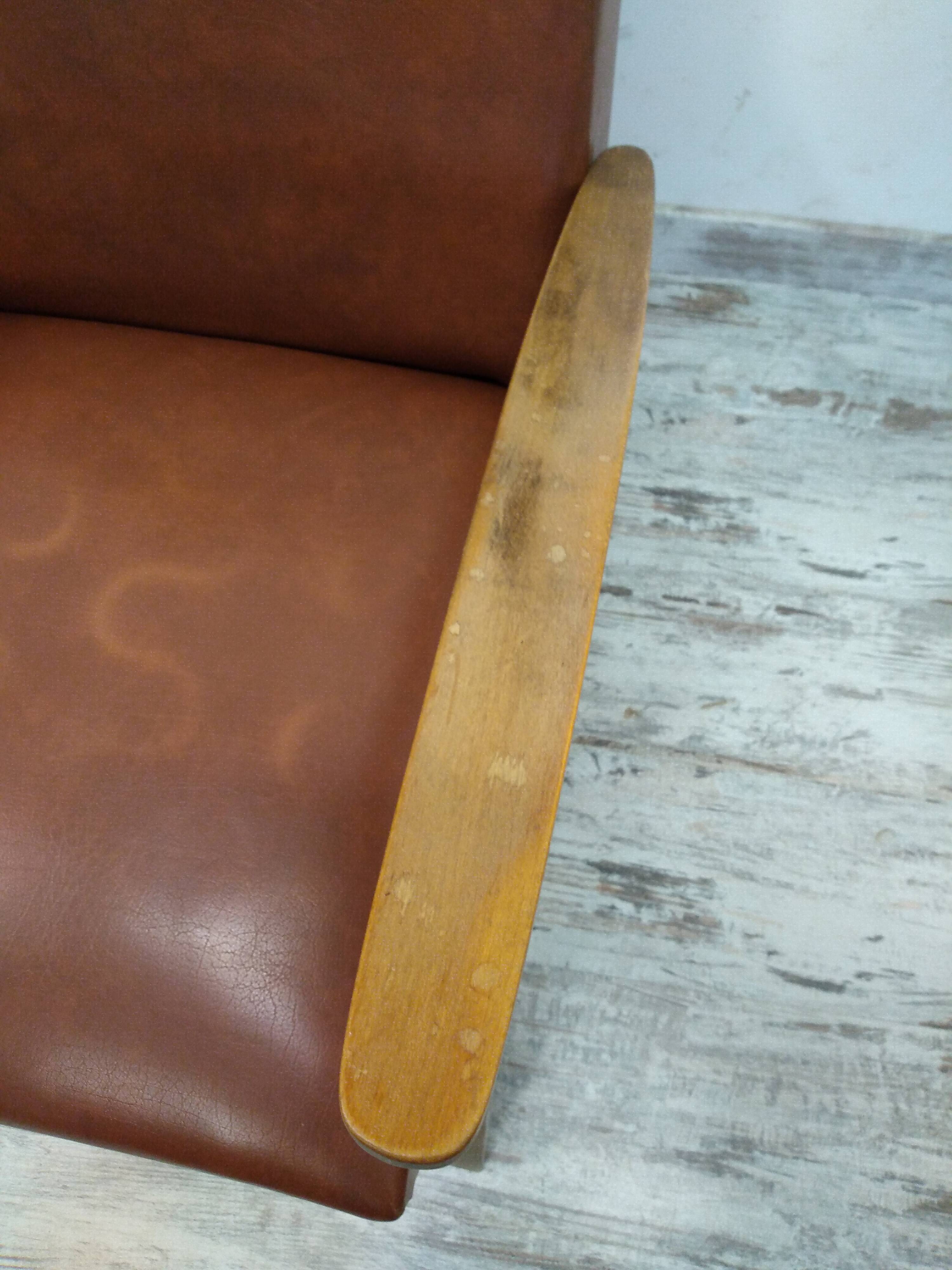 Vintage armchair in wood and imitation leather