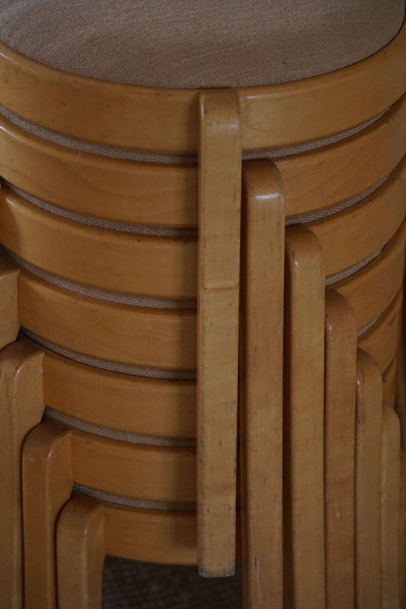 Modern Swedish, set of 14 stackable stools in birch and hessian fabric, 1980s.