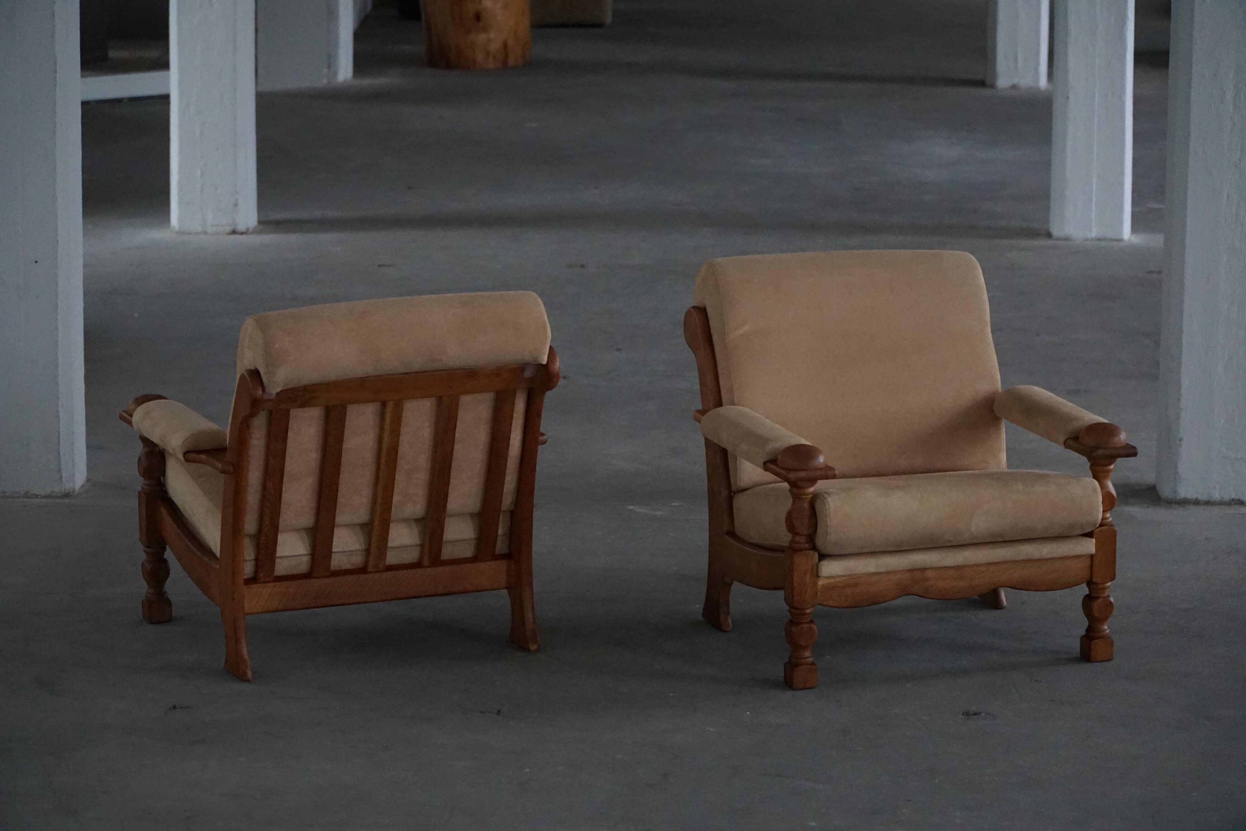 Pair of armchairs by Henning Kjærnulf, Oak Oak and Alcantara, mid-20th century, 1960s.