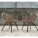 Pair of rattan shell chairs with metallic feet