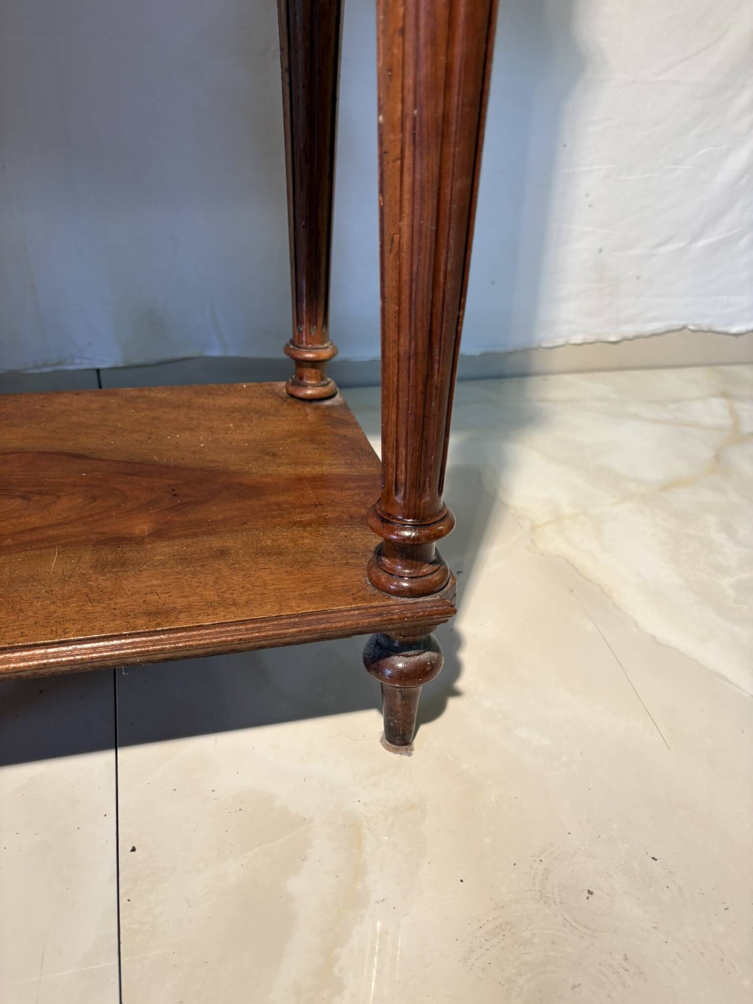 Antique wooden bedside table with turned legs.
