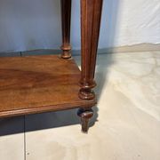Antique wooden bedside table with turned legs.