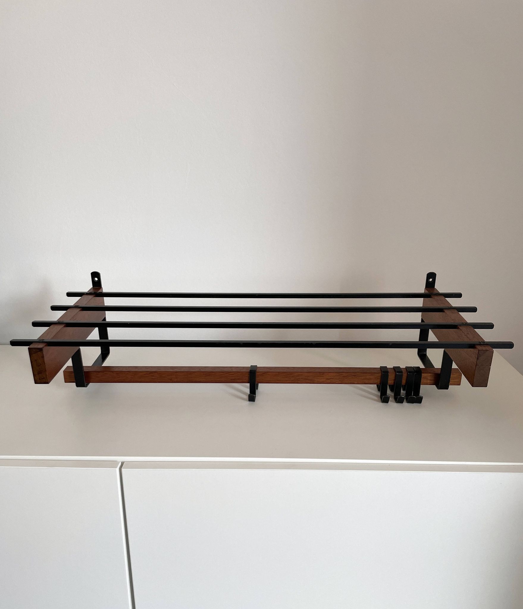 Vintage Scandinavian wall coat rack in wood and metal.