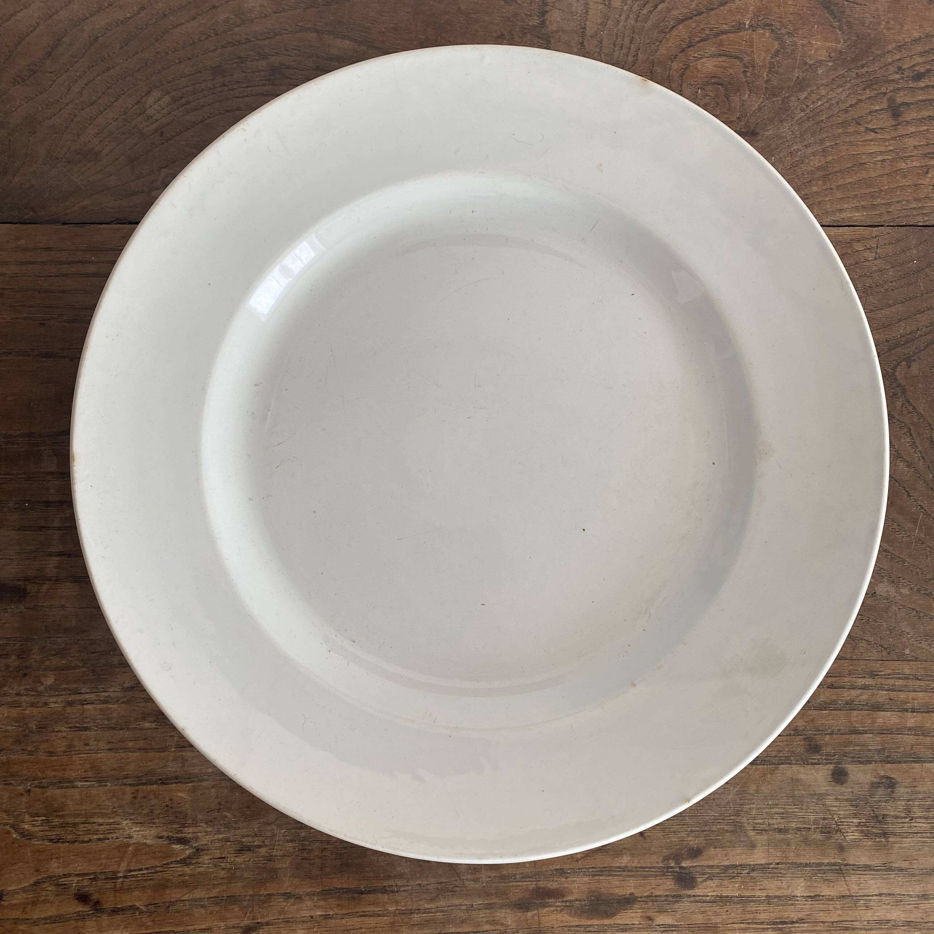 Set of large round white earthenware dishes from Creil and Montereau, 19th century