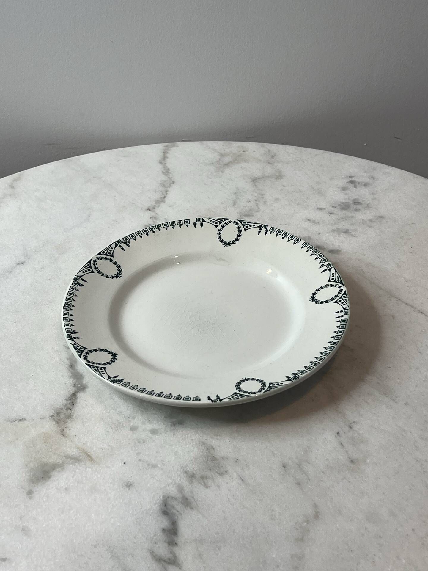 Set of 2 Saint Amand plates with laurel crown decoration.