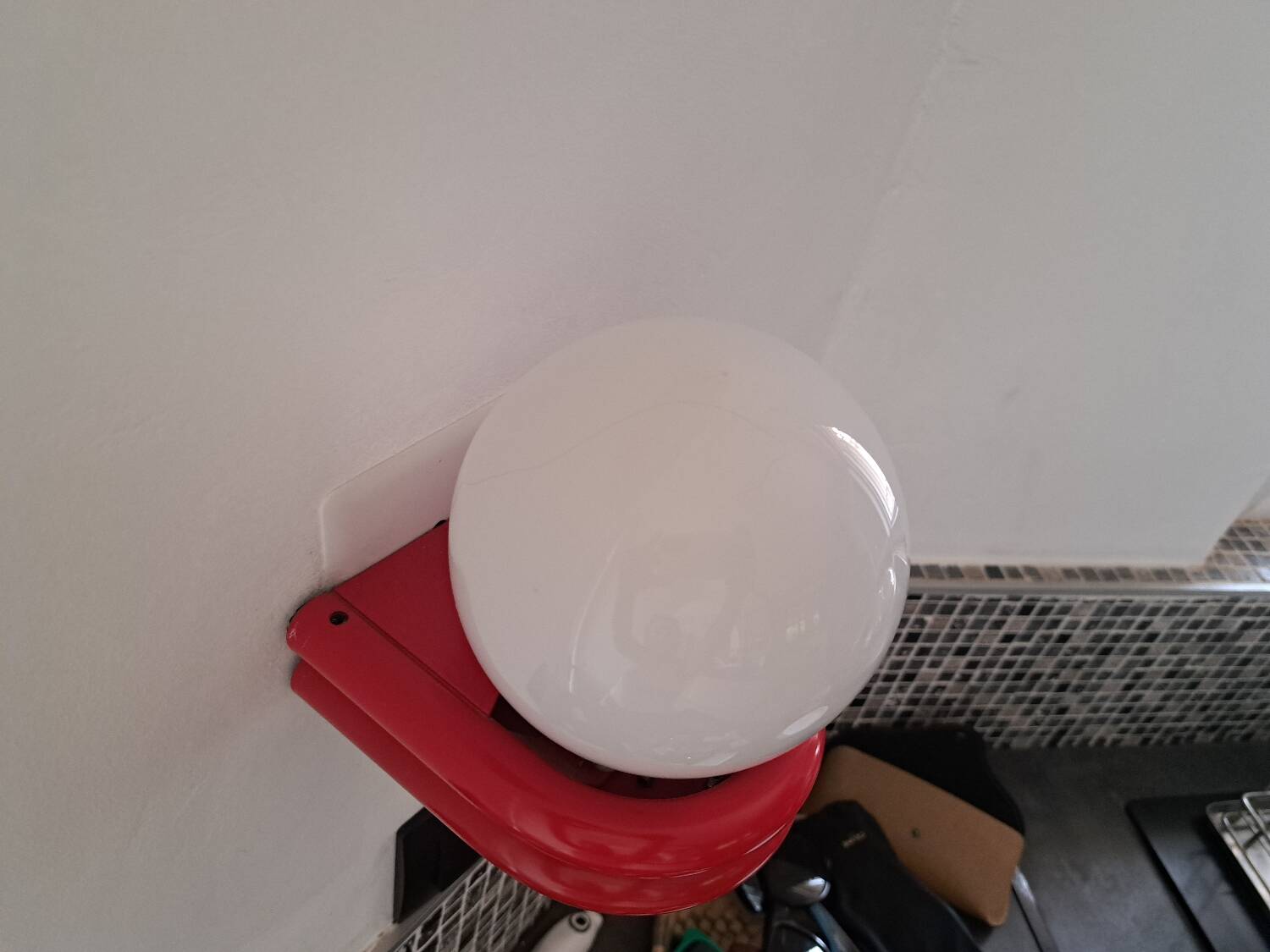 Red metal globe wall light