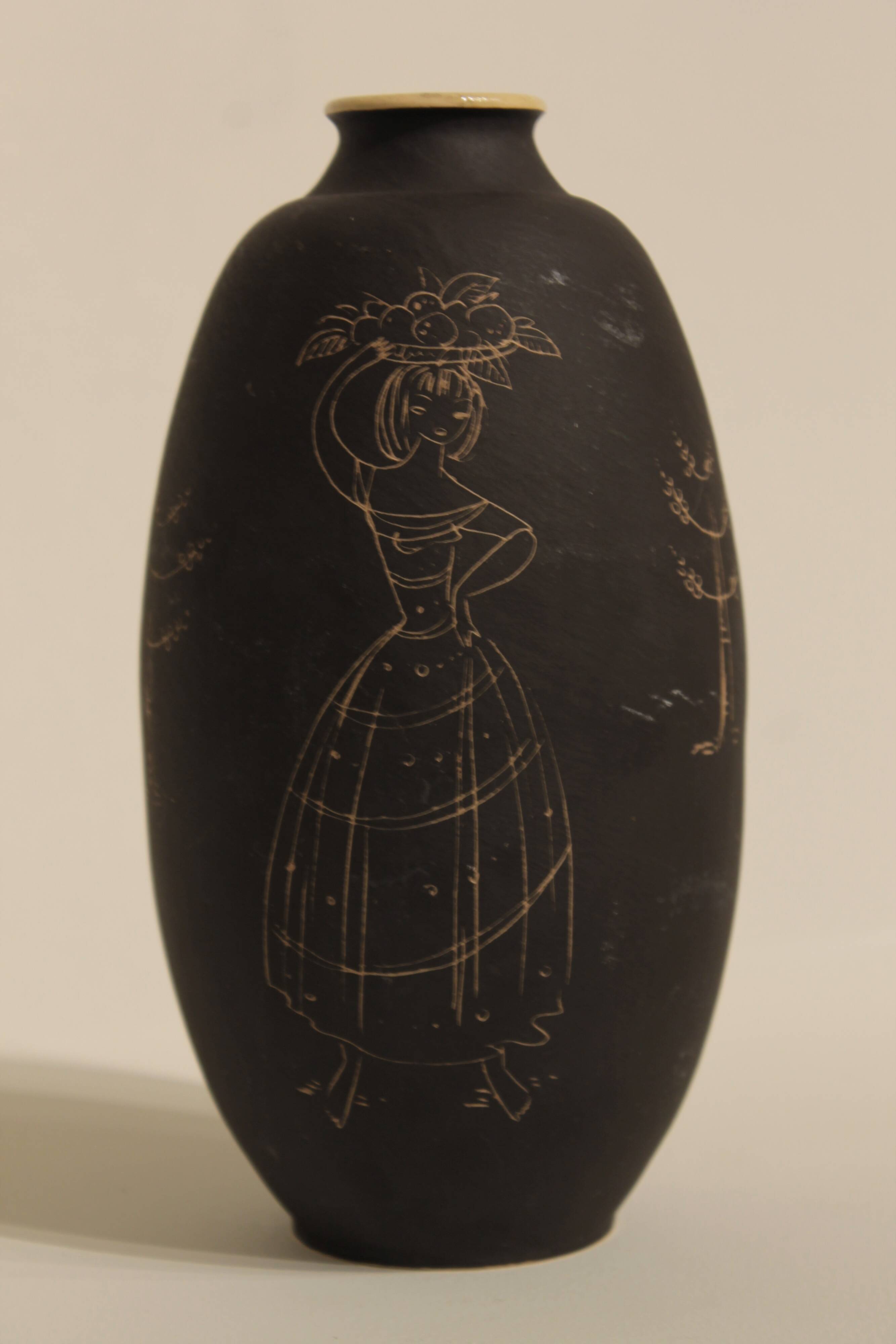 Ceramic vase decorated with women and a tree.