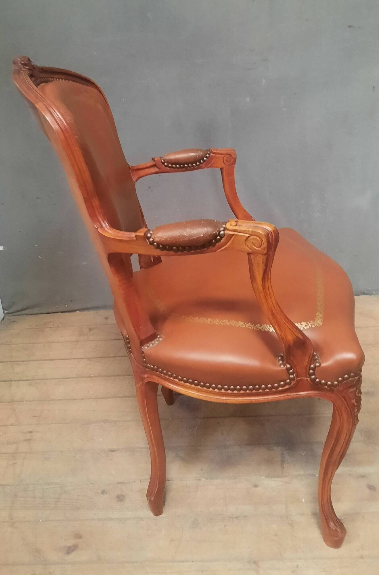 Louis XV style armchair covered in leather.