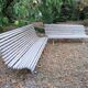 Pair of antique wooden slatted benches with wrought iron legs.