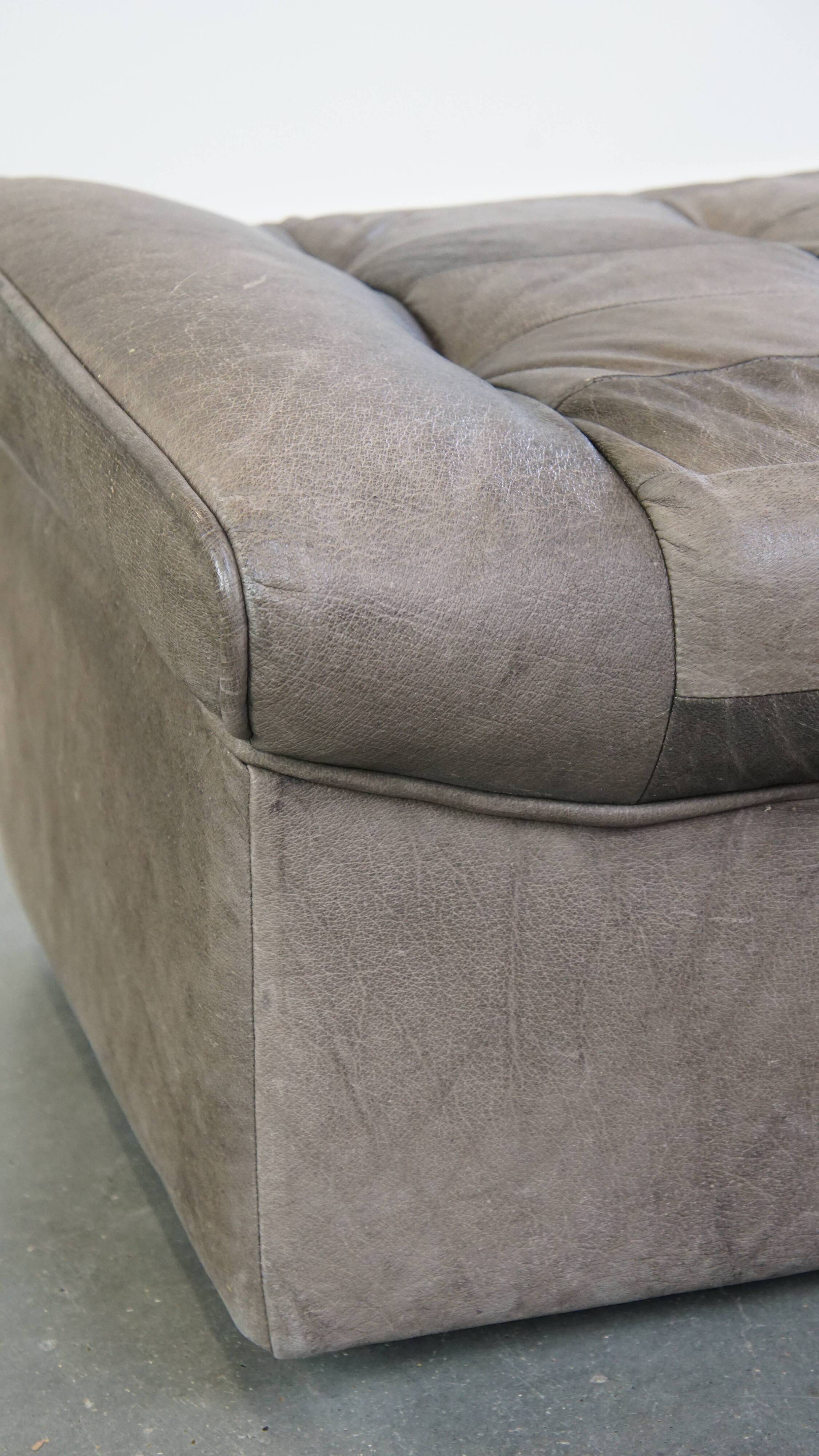 Luxurious, comfortable, gray leather vintage footstool