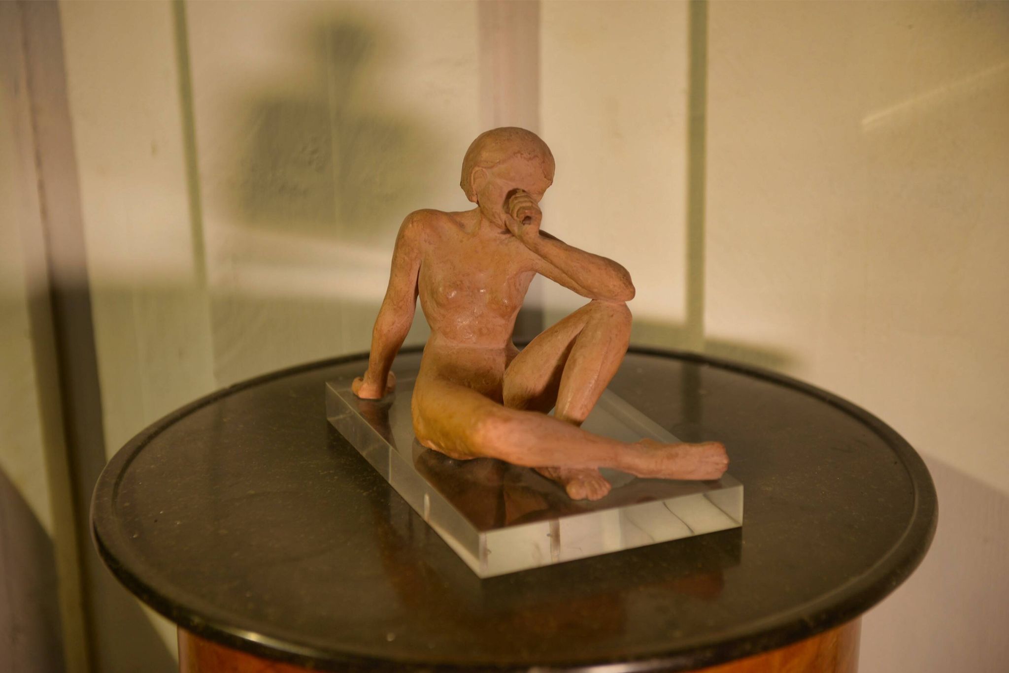 Terracotta sculpture of a seated woman by Norbert Treca contemporary art.