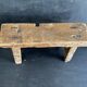 Ancient Chinese farm bench in patinated wood, small rustic stool.