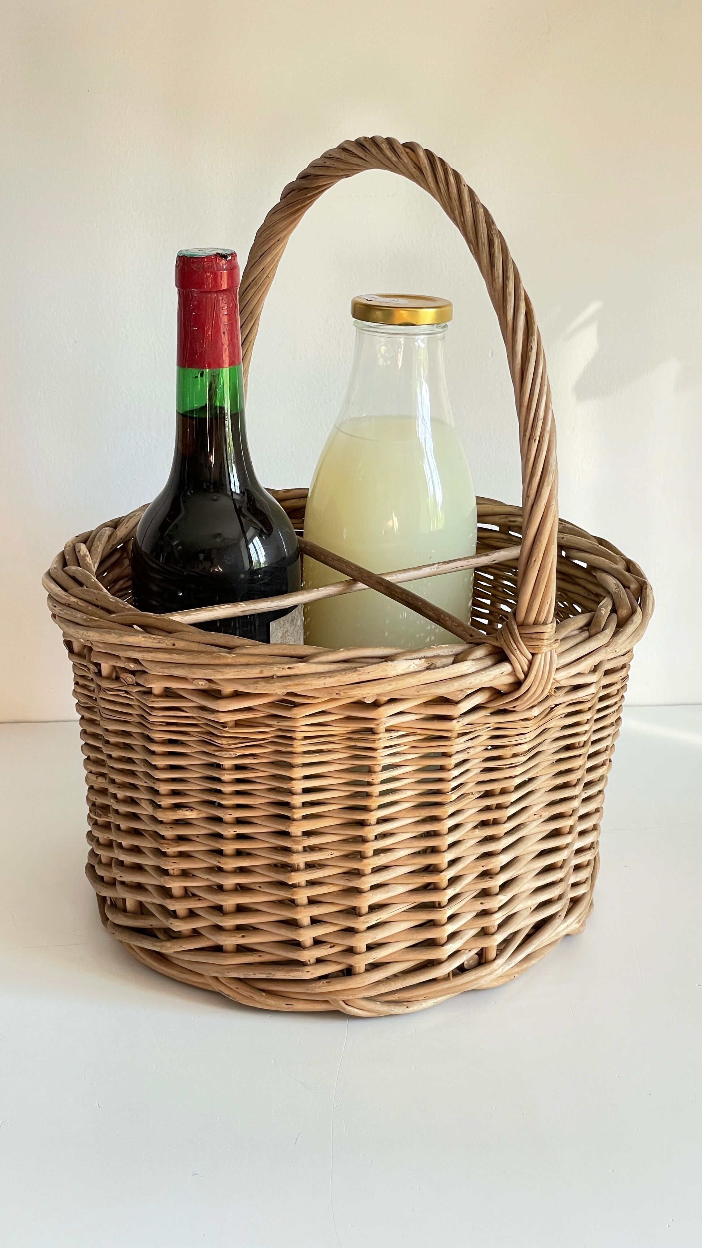 Basket with vintage rattan bottles