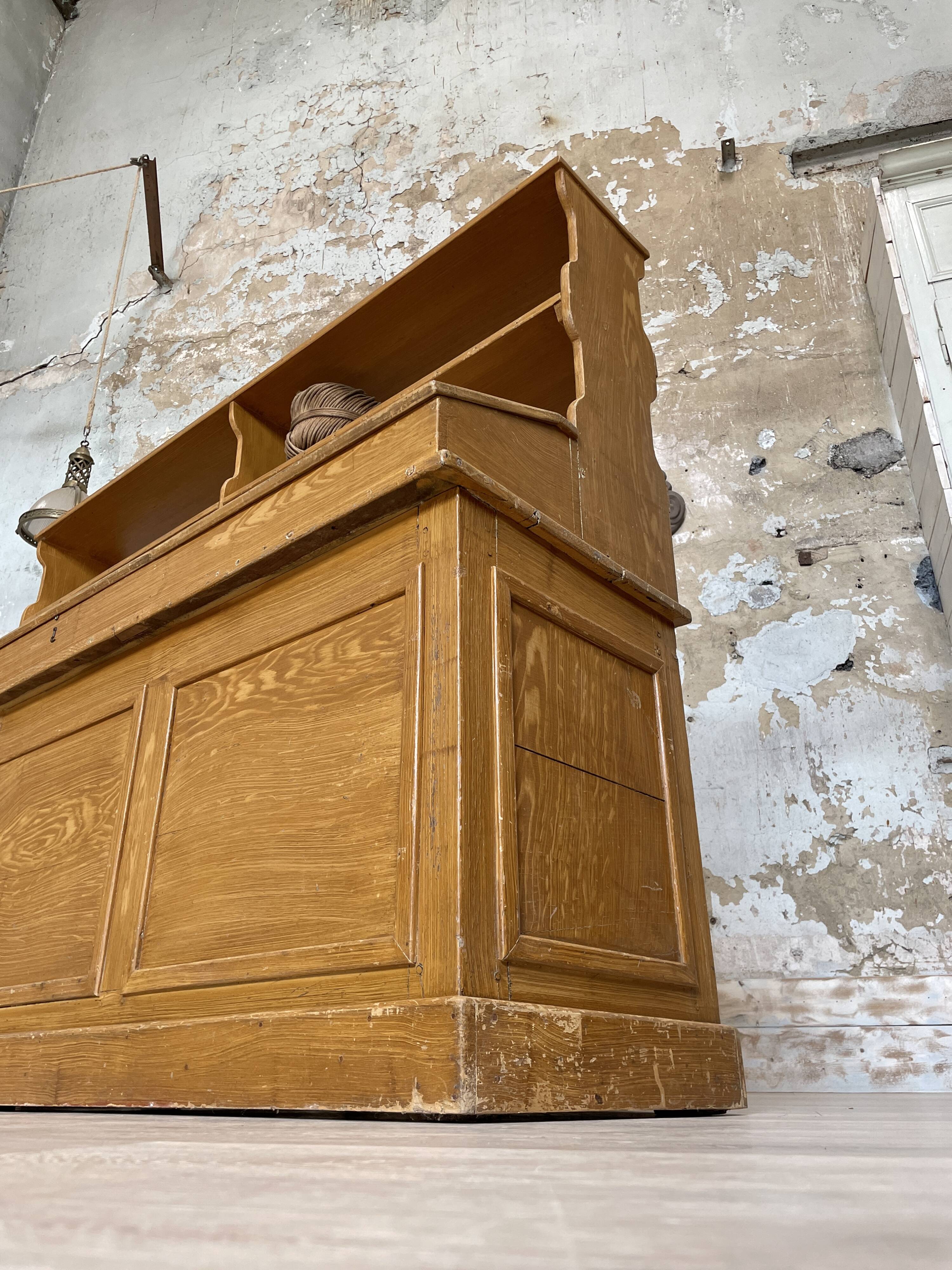 Wooden hardware cabinet painted with wood effect, circa 1940.