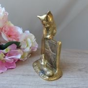 Golden brass cat figurine on fence looking at a mouse in a Vintage India shoe