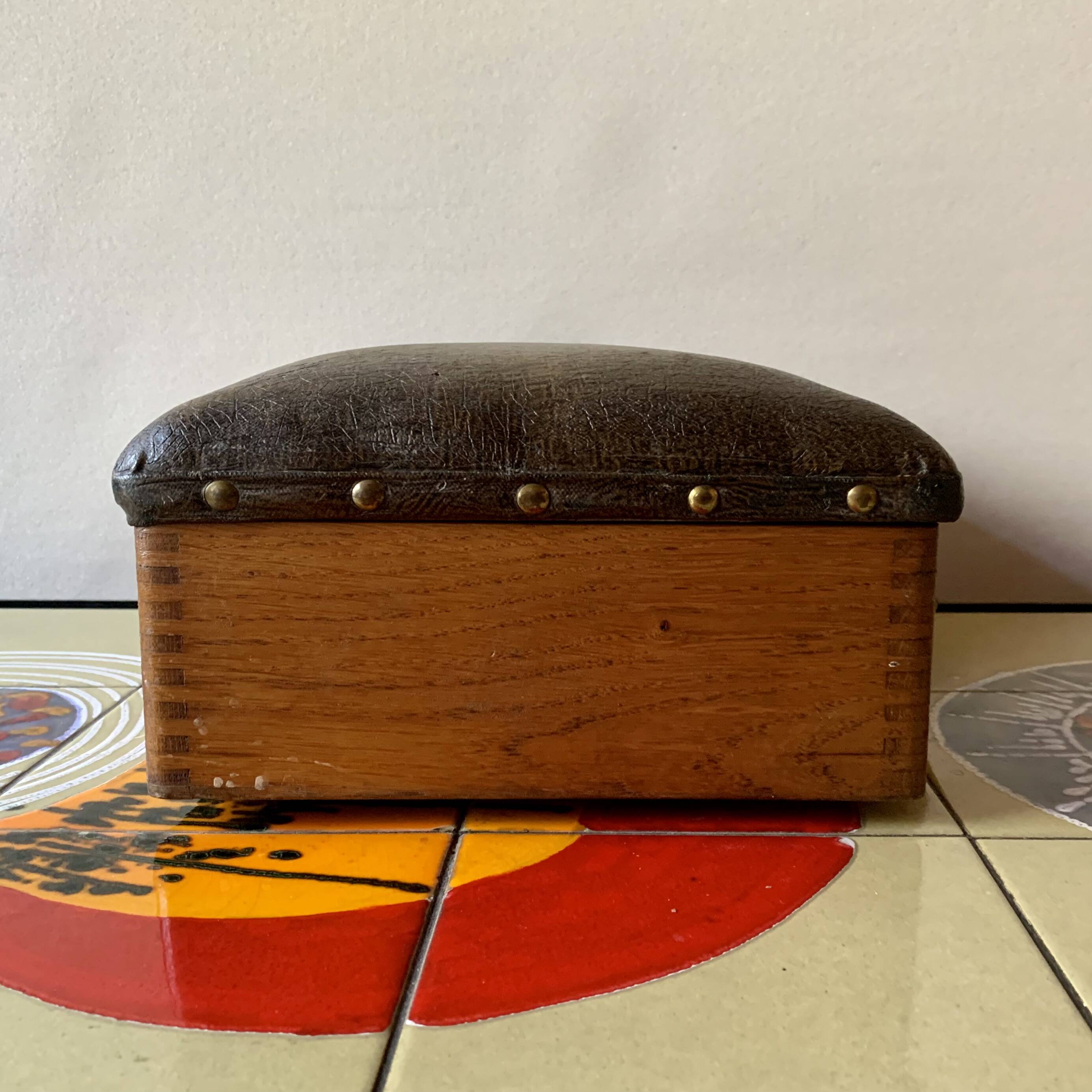 Old foldable fisherman's stool in wood and leather