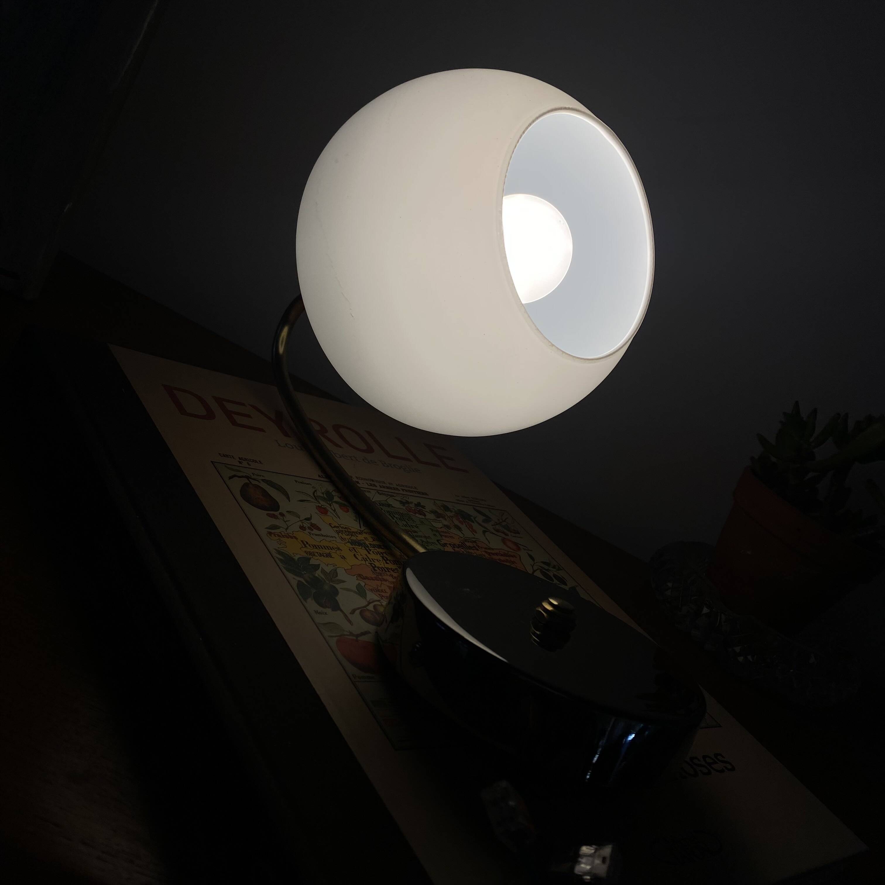 Antique swan neck wall light in brass with a white opaline tulip shade.