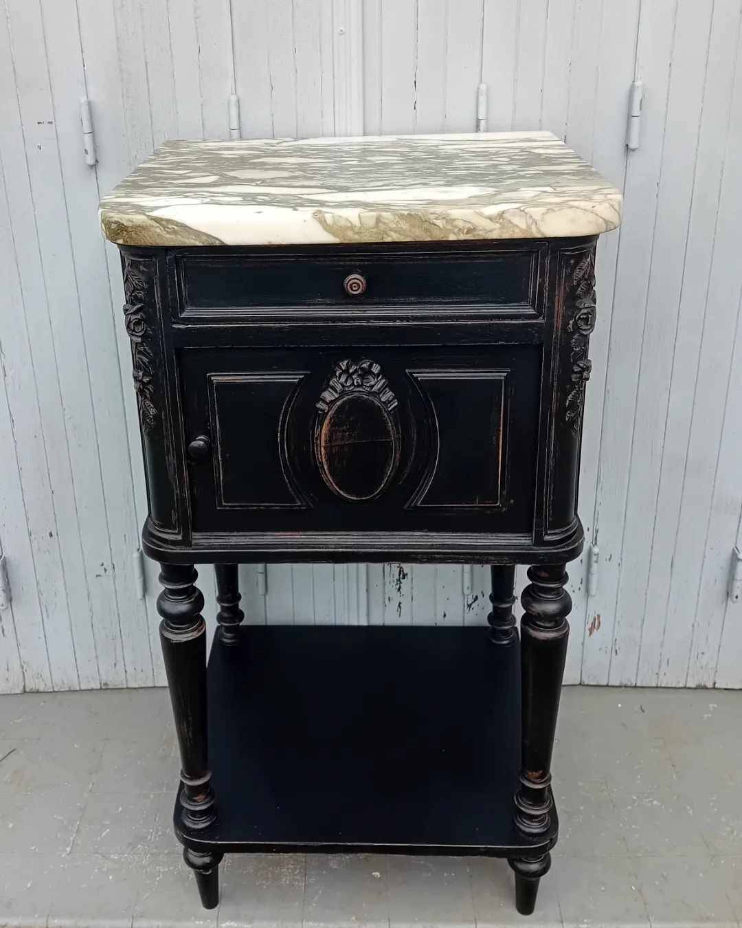 Romantic black bedside table with patinated marble and wood