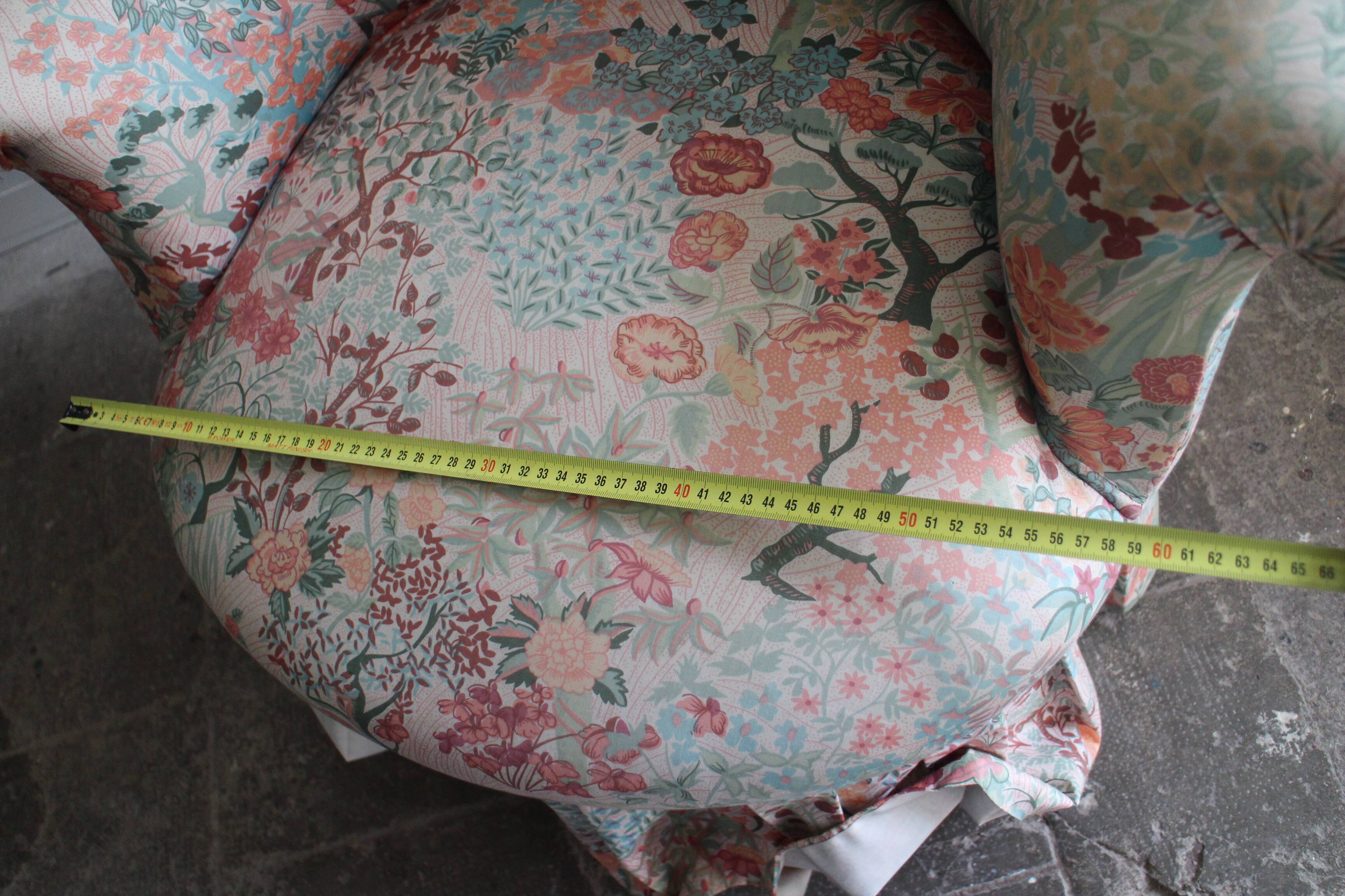 pair of toad armchairs in floral fabric.