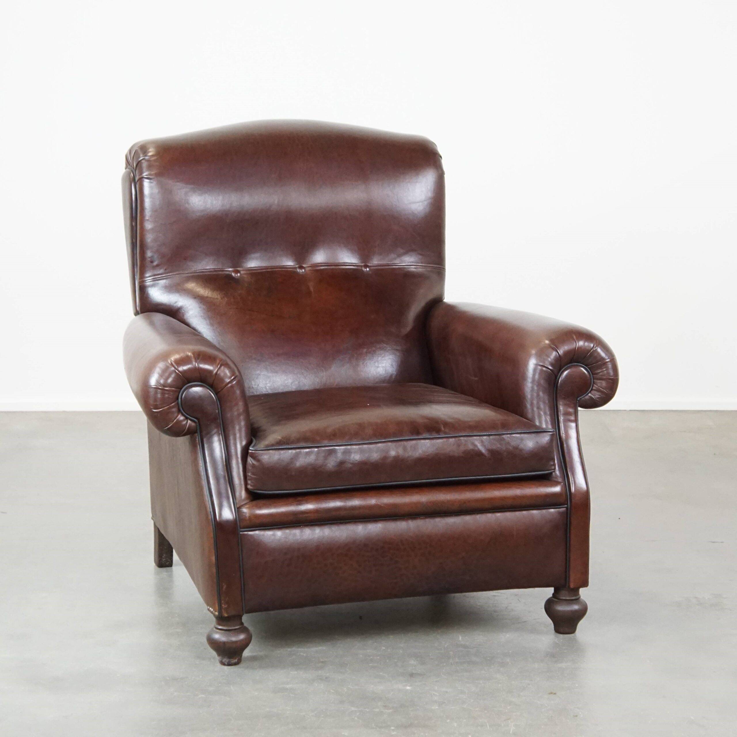 Comfortable and correct dark antique sheepskin English armchair in very good condition