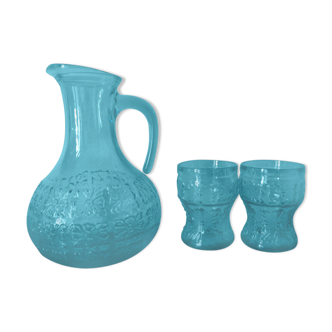Blue glass carafe and two glasses