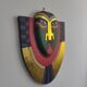 Handcrafted decorative wall mask made of painted wood.